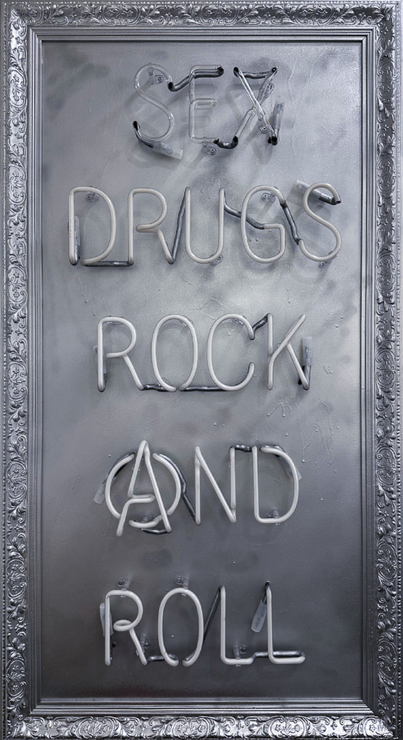 Mark Sloper "Sex, Drugs, Rock and Roll" hand-blown neon sign lit up in vibrant multi-colours on a hand-sprayed panel. A bold punk-inspired statement piece by Illuminati Neon, available at Creed Gallery Ascot.