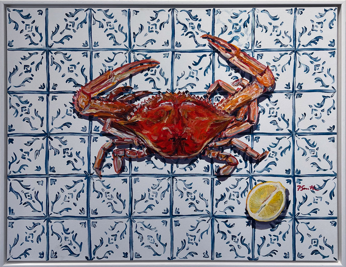 Pippa Smith Crab on Blue Tiles, a red crab and a halved lemon on blue and white tiles, in a white frame