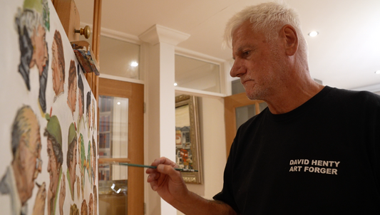 David Henty at work in his studio, adding fine detail to a canvas wearing his signature David Henty Art Forger t-shirt