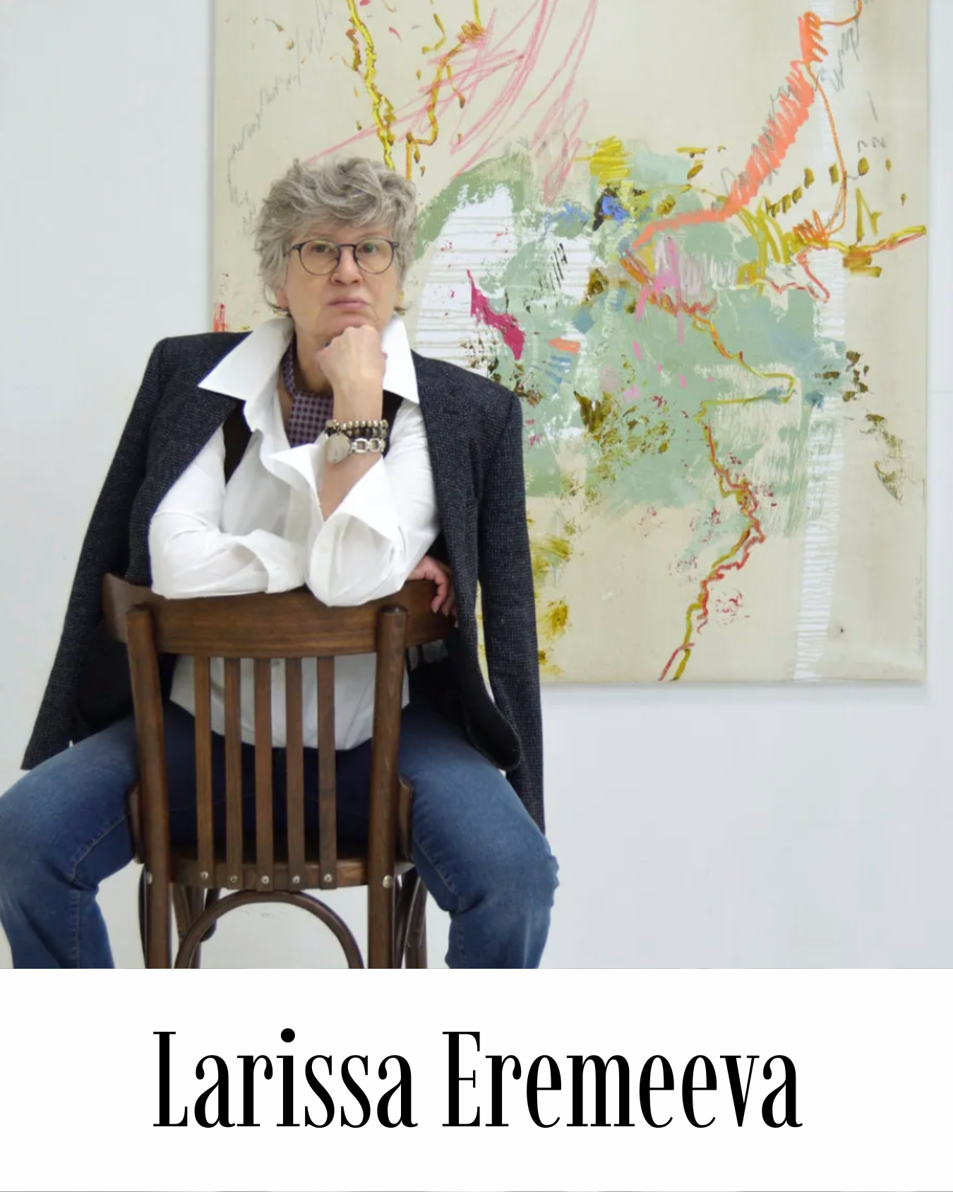 Larissa Eremeeva photographed in her studio, seated in front of one of her large-scale gestural abstract paintings in sage green, cream and pink