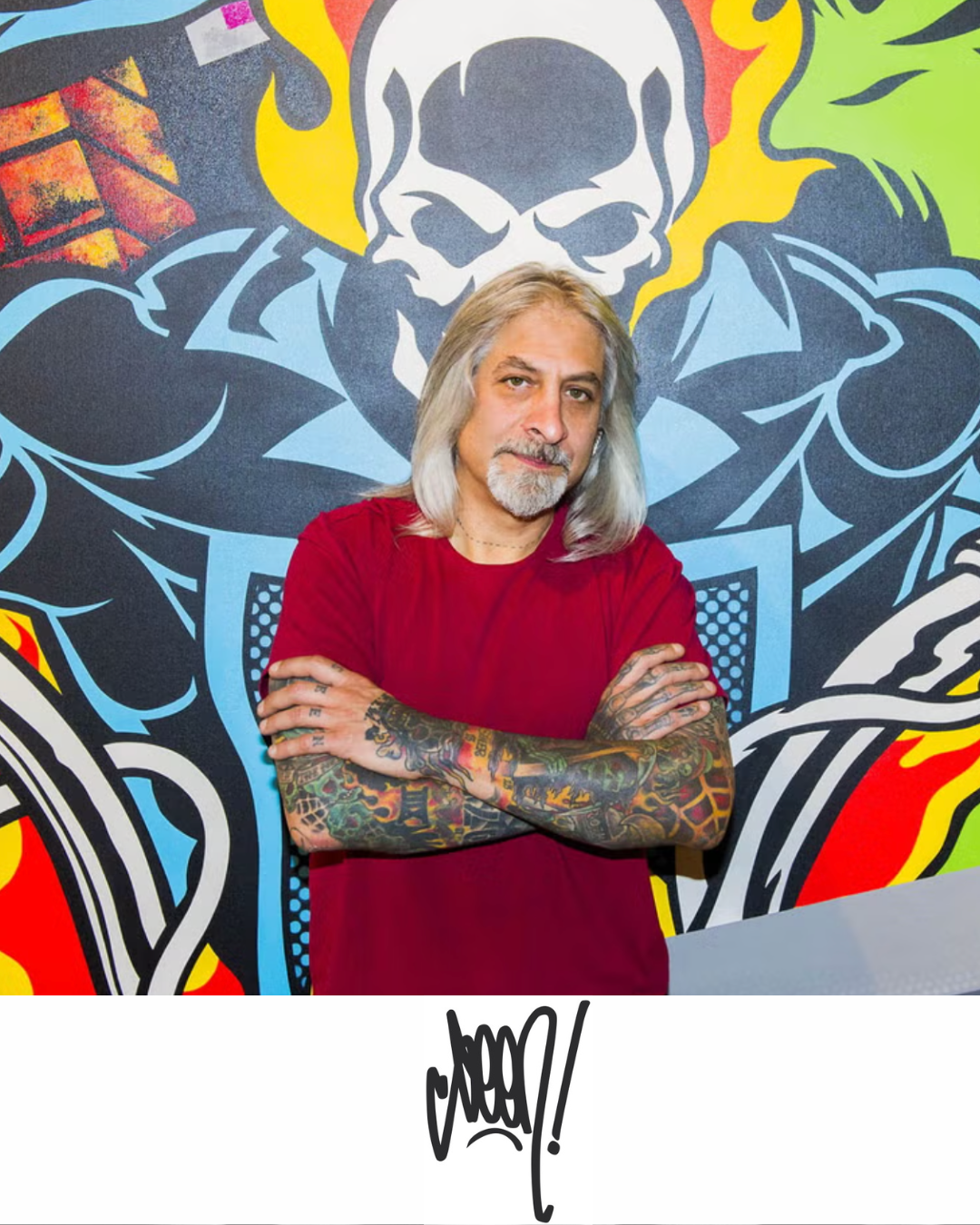 Seen (Richard Mirando), the Godfather of Graffiti, photographed in front of a large colourful skull mural with his signature tag below