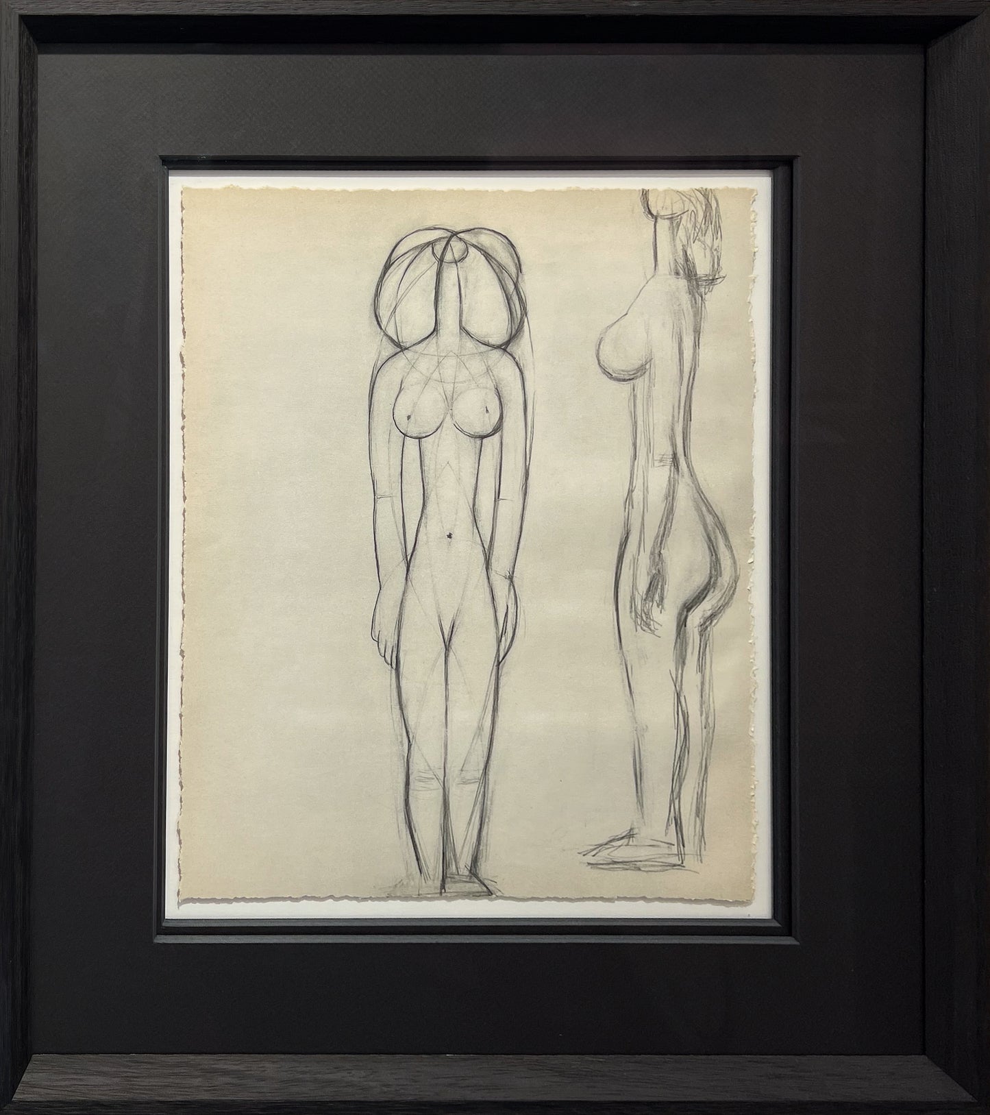 Picasso pencil studies of two standing female nudes, one built from geometric construction lines, one in profile