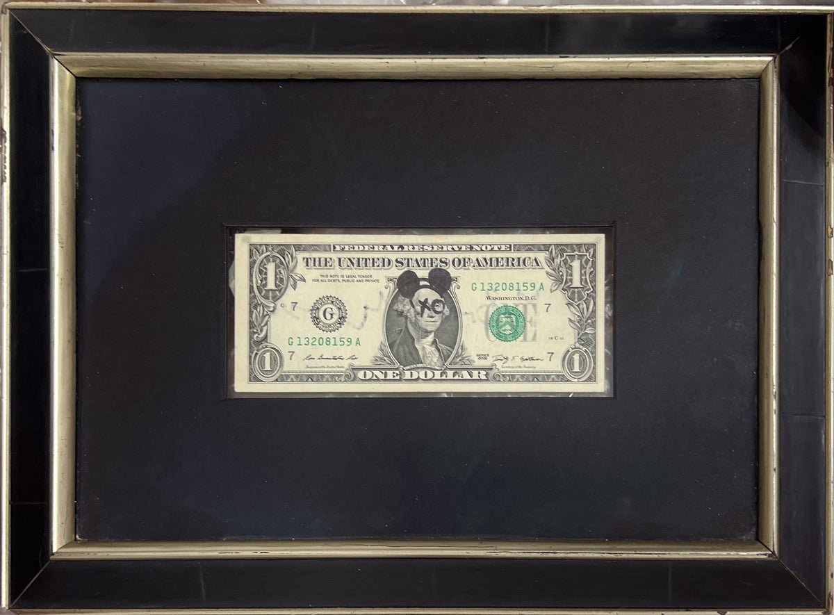 US dollar bill stencilled with Banksy imagery from the 2015 Dismaland Bemusement Park