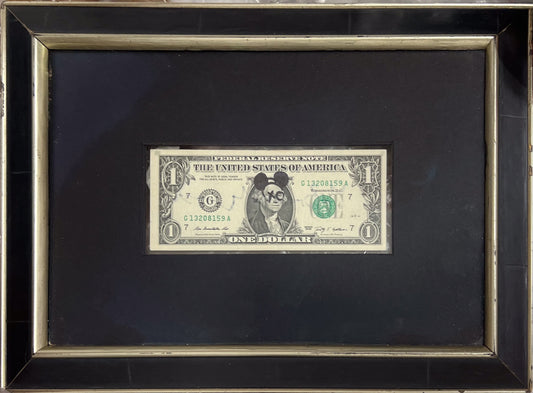 US dollar bill stencilled with Banksy imagery from the 2015 Dismaland Bemusement Park