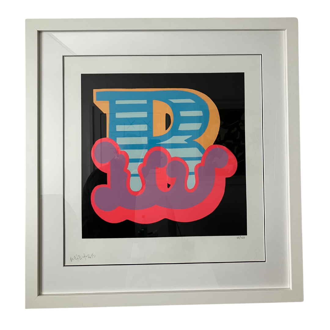 Ben Eine 'B - Purple' signed limited edition print professionally housed in a white frame, on display at Creed Gallery near Windsor.