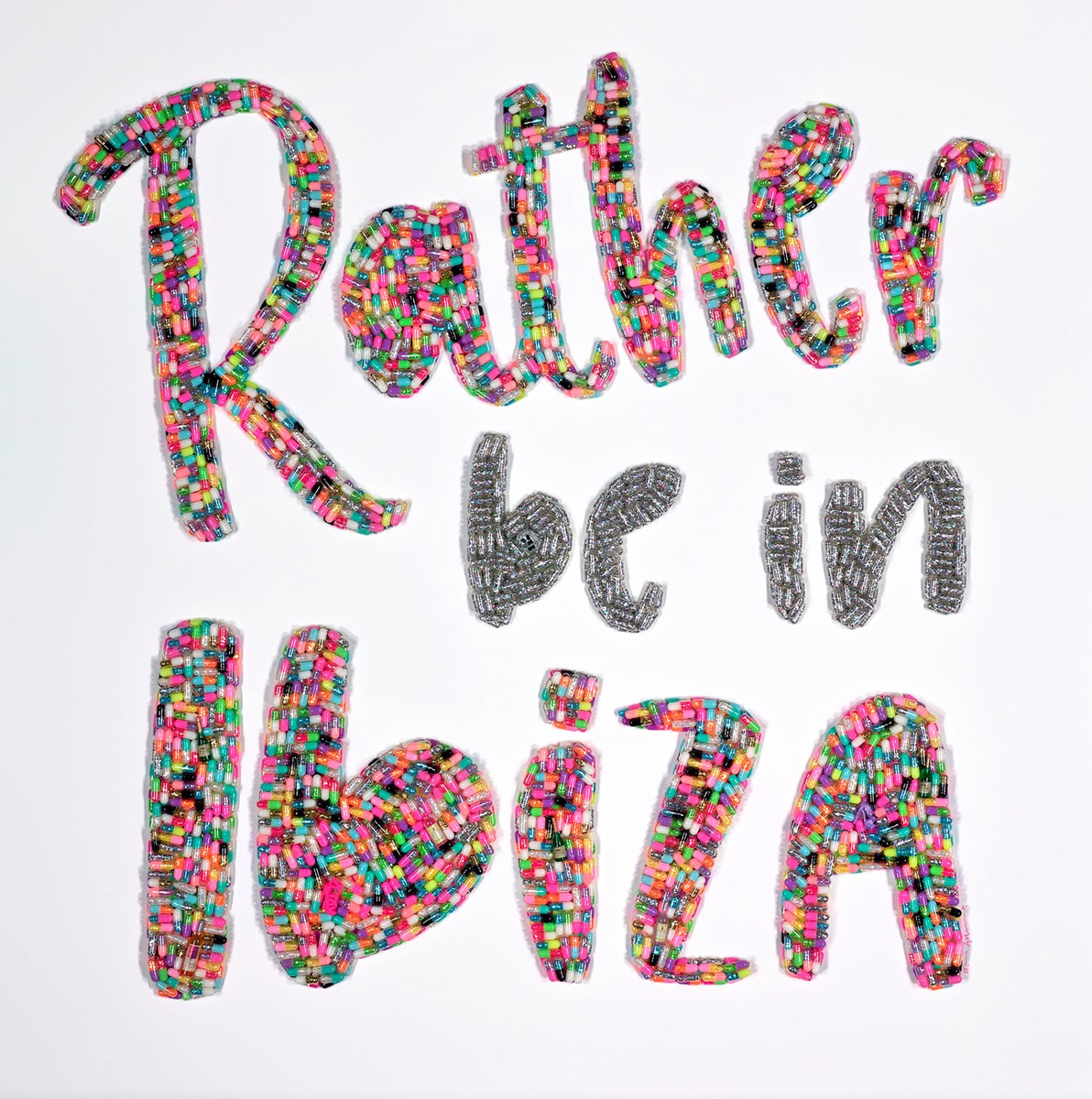Unique original mixed-media artwork "Rather be in Ibiza" by Emma Gibbons, featuring hand-crafted resin pills composed of pharmaceutical capsules and glitter on a black background, framed.