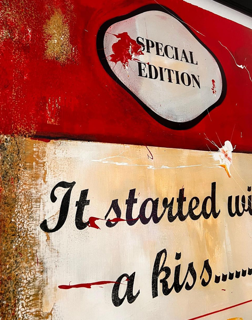 James McQueen 'It Started With A Kiss' unique original painting, detail of the hand-stencilled 'Special Edition' mark above the hand-painted title text 'It started with a kiss...' on an aged book-cover surface. Creed Gallery, Ascot.