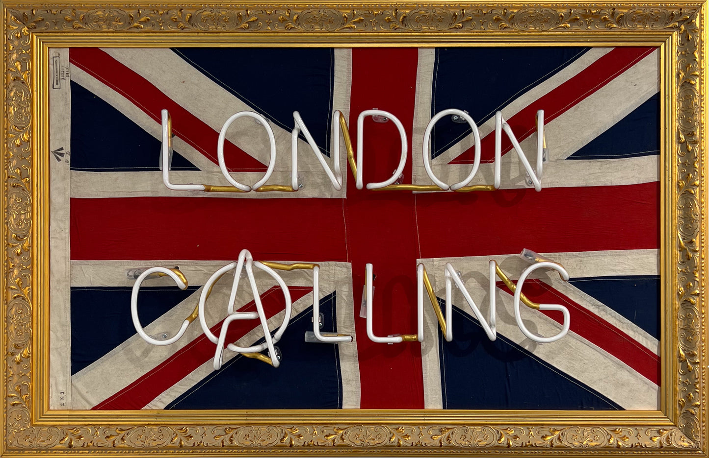 Mark Sloper "London Calling" original neon artwork shown unlit on an authentic vintage 1942 Union Jack flag. Hand-blown glass neon tubing mounted on a historical British flag, available at Creed Gallery Ascot.