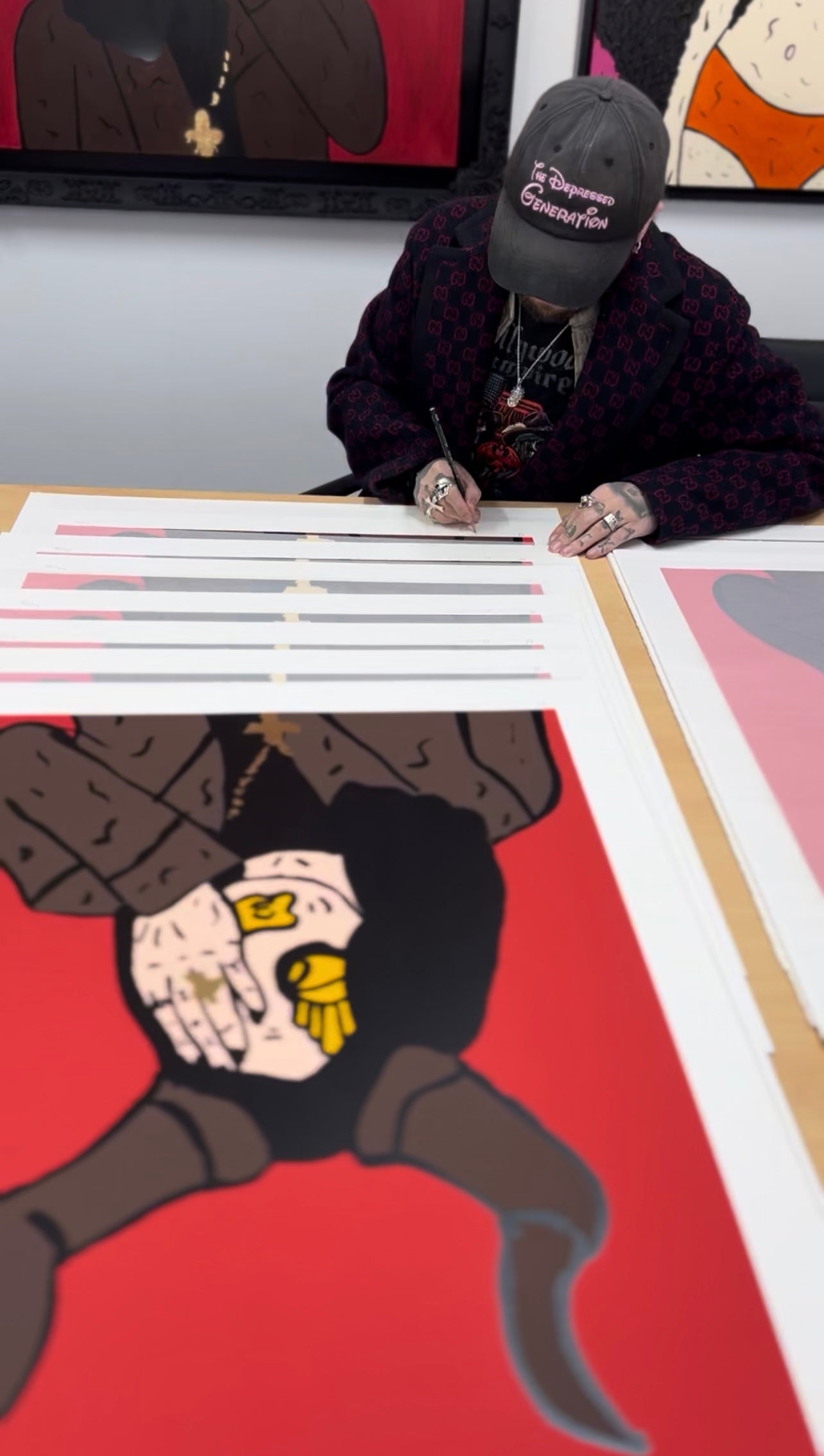 Artist Mason Newman working on a large-scale silkscreen print of Ozzy Osbourne in his studio. The photo shows the manual layering process of the portrait, highlighting the "New Pop" art technique used for the Black Sabbath collaboration.