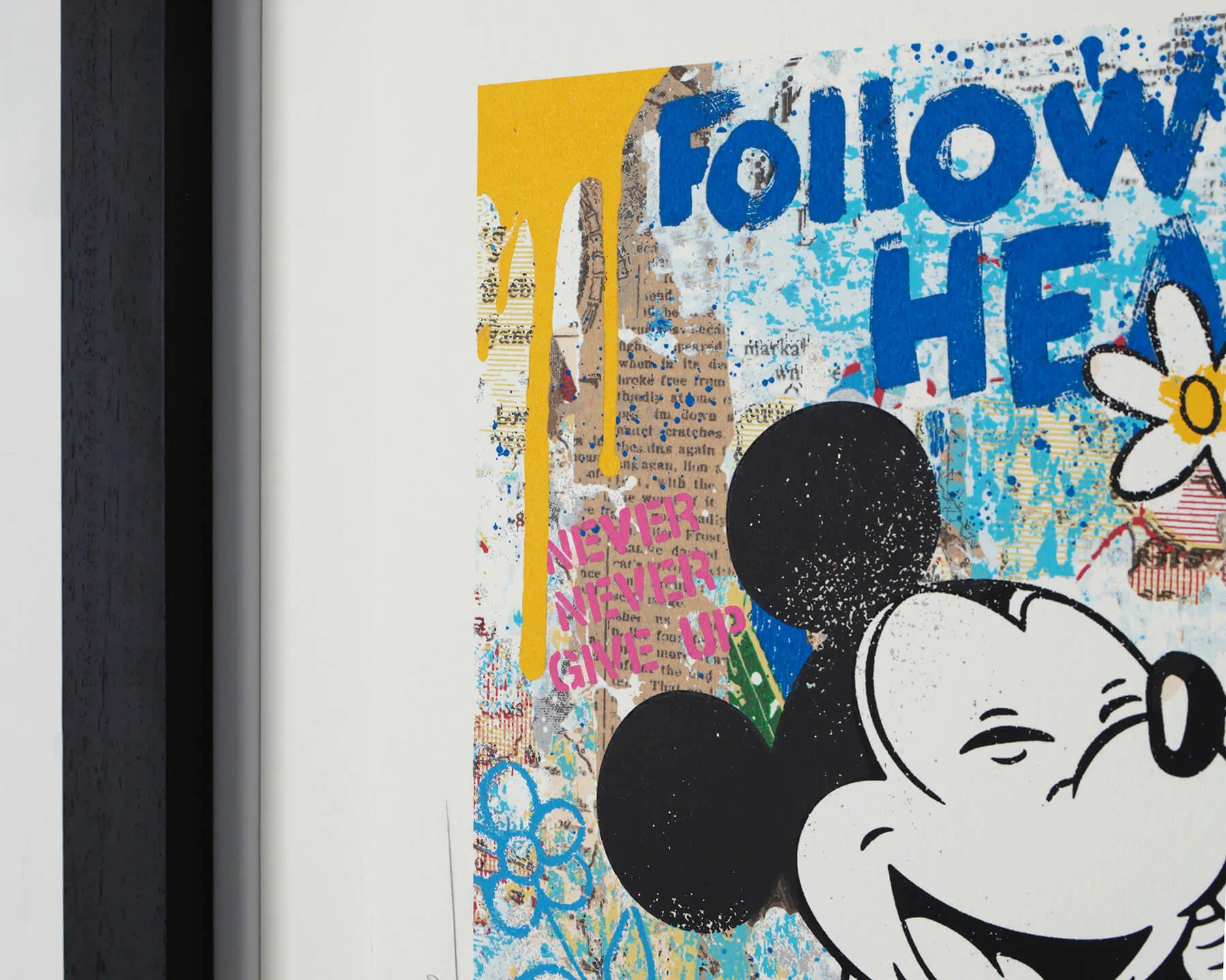 A detailed view of the black contemporary frame and white mount for the "Forever Starts Here" artwork. The image showcases the high-quality finish and official studio stamps from the Disney x Mr. Brainwash global collaboration.