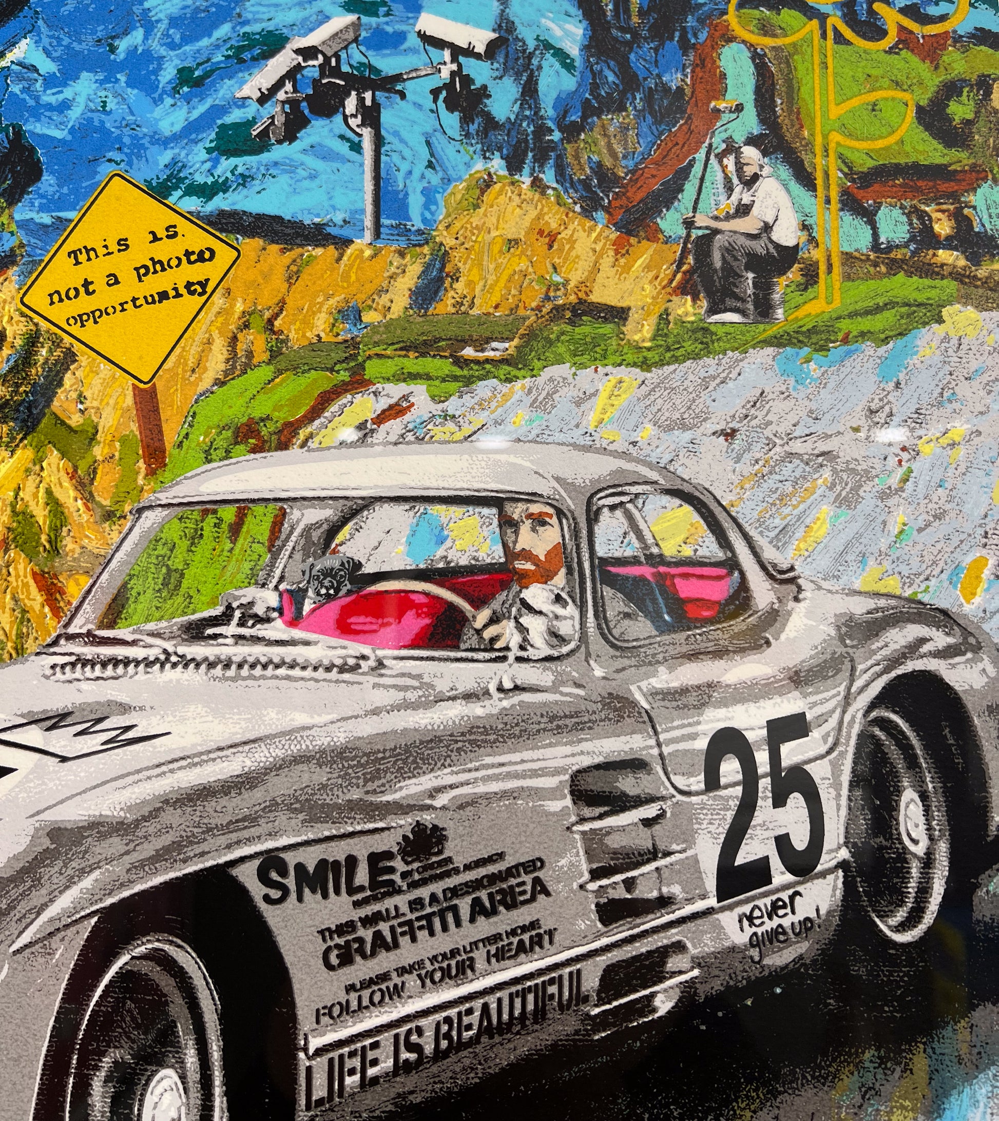 Close-up detail of Mr. Brainwash 'Life is Beautiful' — vintage Mercedes-Benz 300SL race car numbered 25 with 'Life is Beautiful', 'Never Give Up', and 'Smile — Designated Graffiti Area' text, CCTV surveillance cameras and photographer in background, available at Creed Gallery Ascot