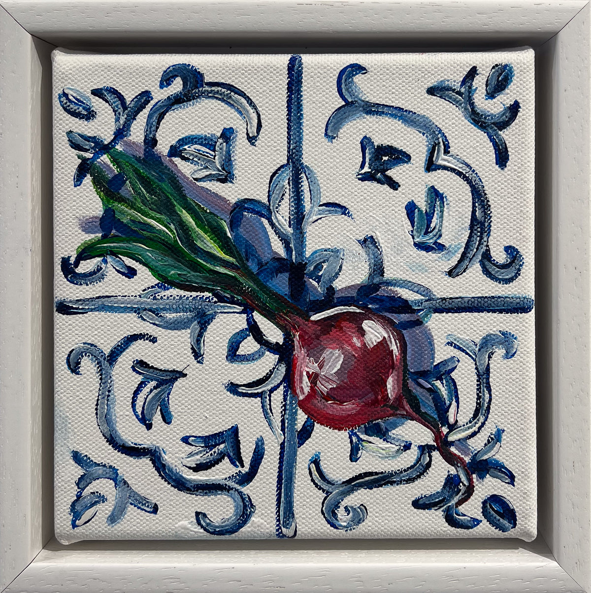 Painted still life of a red beetroot with long green leaves on a blue and white scroll tile, in a white frame