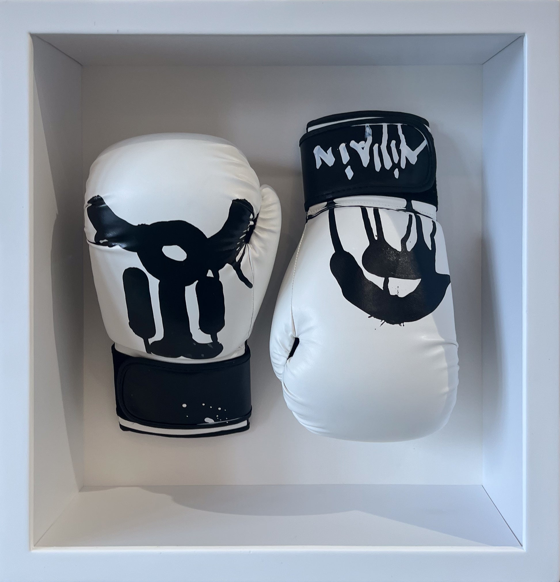Slawn original hand-painted boxing gloves in black and white, framed sculptural work with graphic face design and 'Ninja' lettering. Creed Gallery, Ascot.