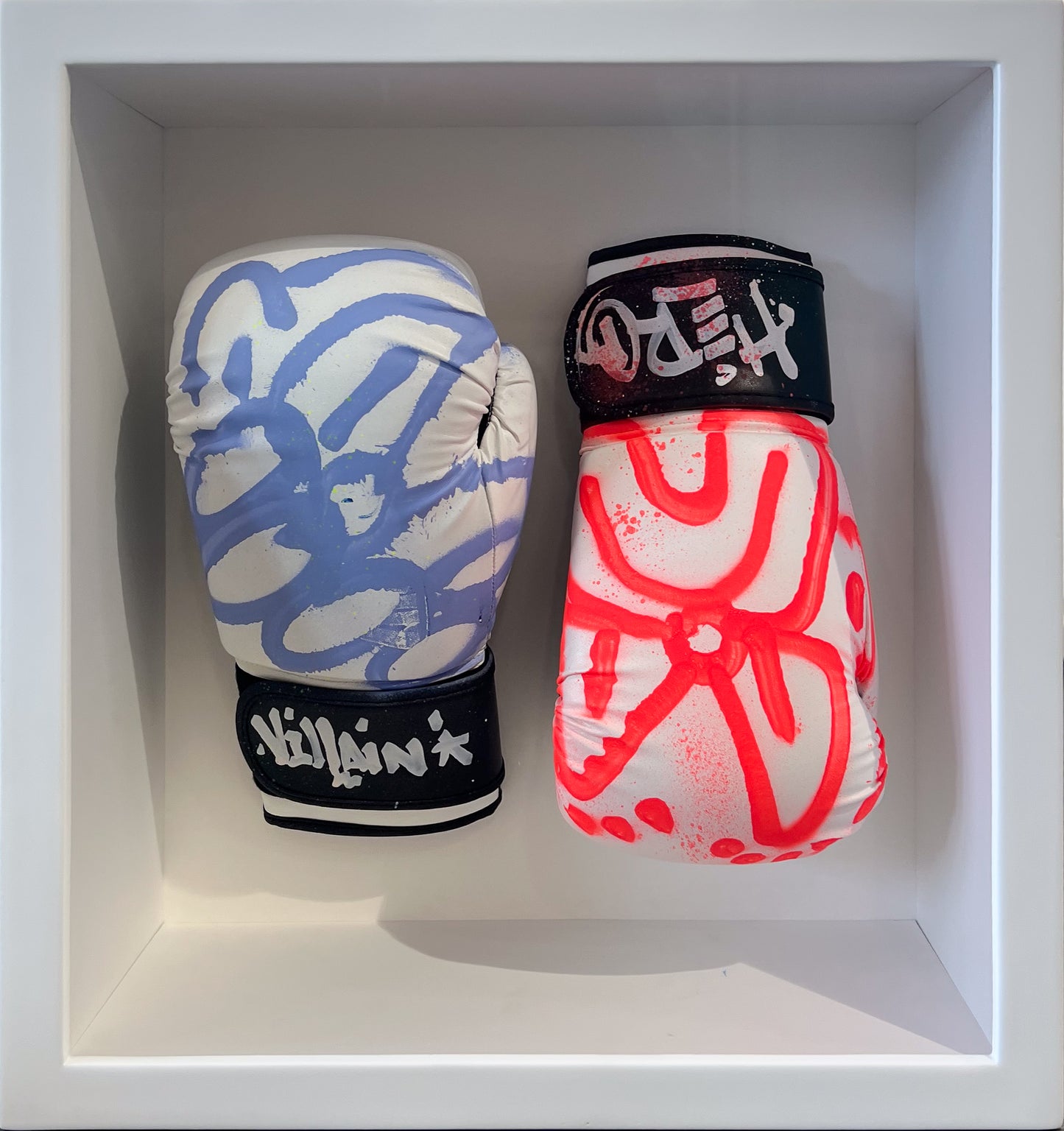 Slawn original hand-painted boxing gloves, pale blue pattern with 'Villain' lettering and bold red 'Desh' design, framed sculptural work. Creed Gallery, Ascot.